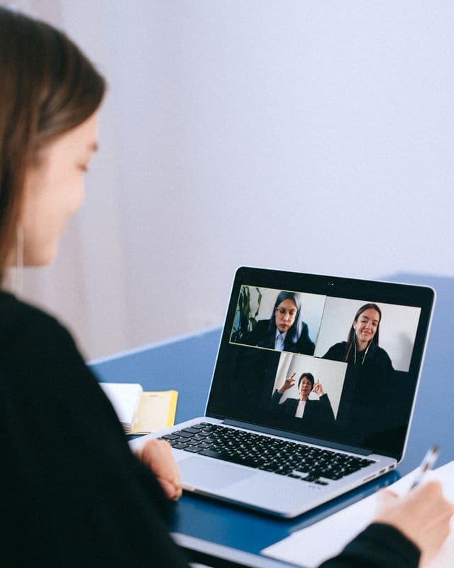 Staff member on a video handover call while taking notes